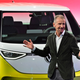A photo of VW CEO Herbert Diess stood in front of an ID Buzz electric van.